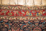 Hand-knotted vintage Bijar rug fringe, cherry red border, budded blossoms, navy Herati motif.