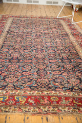Intricate cherry red border, Herati motif, and mostly secured fringe on vintage Bijar.