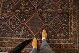 Antique Kamseh carpet field with geometric diamond medallions and stylized birds.