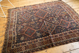 Antique Kamseh carpet: partial geometric medallion, bird motifs, and navy, red patterned border.