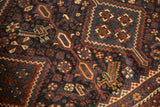 Antique Kamseh carpet showing stylized bird, stepped navy medallion, chestnut, and dusty gold patterns.