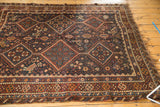Collector antique Persian Kamseh rug with intricate chestnut, navy border and tattered fringe.