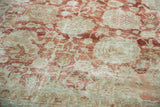 Distressed vintage Tabriz rug, highlighting faded terracotta, beige, and powder blue palmette motifs.