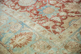 Vintage distressed Tabriz carpet detail: faded cherry red, powder blue palmette and vinery pattern.