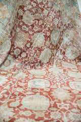 Decorative distressed texture with faded palmette and vinery motifs in red, blue, and ivory.