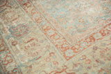 Distressed Tabriz carpet showing slate blue-green Herati pattern and wine red turtle border.
