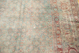 Distressed vintage Tabriz carpet showing faded slate blue Herati and border patterns.