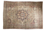 Antique Kermanshah carpet features an oversized scalloped navy blue medallion on an ivory floral field.