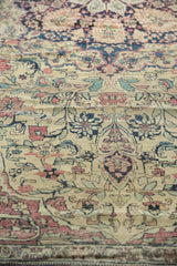 Intricate floral pattern on Antique Kermanshah carpet, featuring antique ivory, cochineal, navy, with mostly even wear.