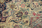 Intricate sprawling floral arrangements on this antique Persian Kermanshah carpet, with time-softened hues.