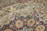 Intricate floral and scalloped motifs with time-softened patina on antique Kermanshah rug.