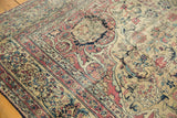 Intricate floral border and field of Antique Kermanshah carpet, ivory, red and blue, mostly even wear.