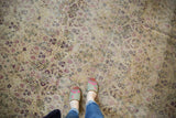 Antique Kerman carpet's curvilinear floral vinery in softened ivory and cochineal red.
