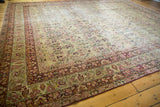 Antique Kerman carpet corner: intricate blossomed vinery in cochineal red on an ivory field.