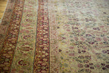 Antique Kerman carpet detail: intricate floral field, cochineal red, ivory, with softened pile.