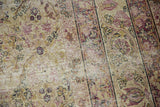 Kerman carpet's intricate floral vinery with cochineal red, antique ivory, and softened tone-on-tone wear.