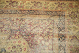 Antique Kerman carpet corner, intricate mil fleur motifs, faded cochineal red, navy border, mostly even wear.