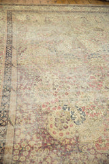 Antique Kerman carpet corner, intricate floral mil fleur design in ivory, cochineal red, and navy tones.