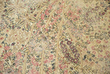 Detail of antique Kerman mil fleur pattern showing cochineal red, navy, and visible knot heads.