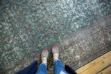 Distressed Persian Mahal carpet: exposed foundation, faded henna field, and floral border.