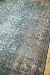 Distressed vintage Mahal carpet displaying muted blue field, faded raspberry floral border, and worn texture.