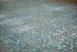 Textured detail of a distressed vintage Mahal carpet in soft sky blue and faded raspberry.