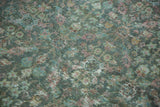 Distressed texture of vintage Mahal carpet, showing worn pile and faded blue, green, red motifs.