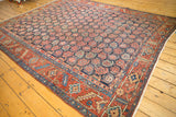 Vintage Heriz corner, unusual allover boteh on navy blue field with evident pile wear.