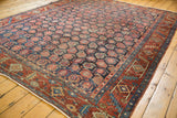 Vintage Heriz carpet corner with unusual allover boteh on navy ground and brick red border.