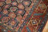 Vintage Heriz rug showcasing unusual allover boteh, navy blue ground, brick red, and gold accents.