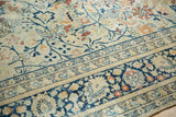 Vintage Tabriz carpet with faded navy scrolling tendrils, terracotta palmettes, and ornate borders.