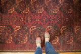 Repeating triple column Gul pattern on vintage Ersari carpet, dark red, navy, apricot.