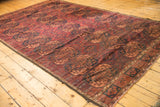Vintage Ersari carpet's repeating Gul motifs in dark red, apricot, navy, low pile.