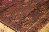 Vintage Ersari carpet's distinct dark red, navy, apricot Gul pattern, low pile, and decorative border.