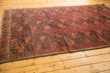 Reinforced side and repeating Gul Ersari pattern in dark red, apricot, and navy blue.