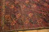 Ersari carpet detail: dark red, navy, apricot repeating guls, low pile, secured end.