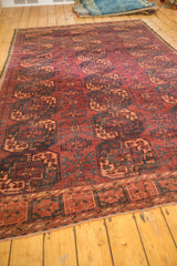 Ersari rug's repeating Gul pattern, low pile, and secured side edge in dark red, apricot, navy.