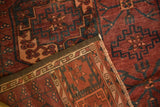 Ersari carpet's neatly bound side and repeating dark red geometric Gul pattern.