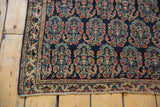 Secured bottom edge of antique Afshar rug, showing fine weave, mostly even low pile, red, gold, navy boteh patterns.