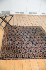 Close-up of antique Afshar with intricate boteh motif, mostly even low pile, traditional border.