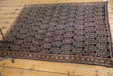 Detailed corner of antique Afshar rug, featuring secure, stabilized border and boteh motif.