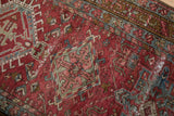 Distressed texture of Karaja runner with low pile, knot heads, and visible foundation.