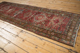 Distressed Karaja runner corner, showing low pile, knot heads, red and teal geometric border.
