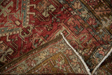 Close-up of a folded Karaja runner, revealing distressed low pile, visible foundation, and geometric patterns.