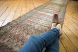 Distressed vintage Serbend runner displaying allover faded terracotta and sky blue boteh motif.