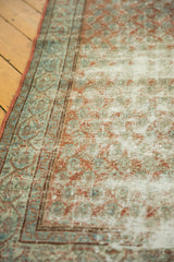 Distressed Serbend rug texture, showing terracotta, sky blue, and ivory boteh motifs.