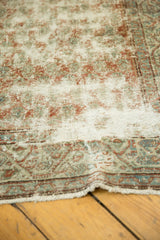 Distressed pile texture of a vintage Serbend runner with faded terracotta and sky blue hues.