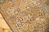 Distressed Malayer runner: intricate boteh paisley pattern, low pile, faded gold, blush, and powder blue.