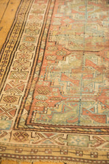 Geometric tribal border and distressed texture on vintage Ersari rug in muted tones.