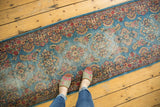Vintage Kerman rug runner edge, showing sky blue field with cochineal red and ivory floral bouquet sprays.